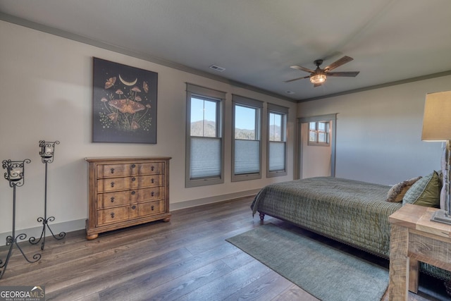 bedroom featuring ceiling fan, ornamental molding, and hardwood / wood-style floors