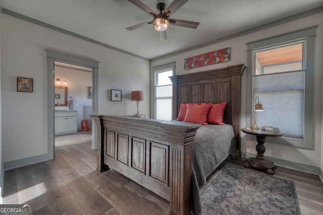 bedroom featuring dark hardwood / wood-style flooring, connected bathroom, ornamental molding, and ceiling fan