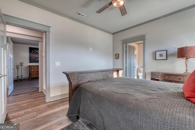 bedroom featuring ornamental molding, wood-type flooring, and ceiling fan