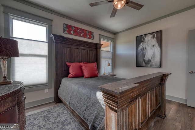 bedroom featuring crown molding, wood-type flooring, and ceiling fan