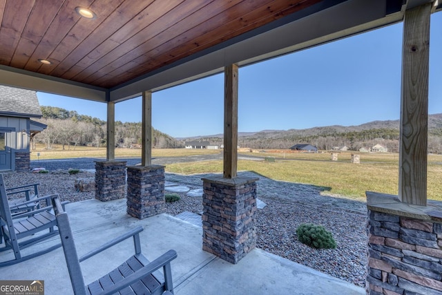 view of patio / terrace with a mountain view and a rural view