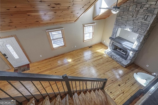 bonus room with lofted ceiling, ceiling fan, a fireplace, wood-type flooring, and wooden ceiling