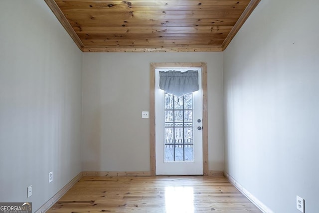 entryway featuring ornamental molding, light hardwood / wood-style floors, and wooden ceiling