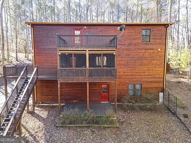 rear view of property with a balcony