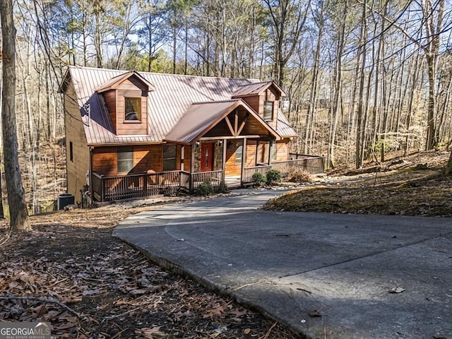 view of front of home featuring cooling unit and a porch