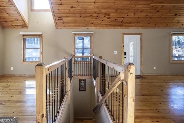 staircase featuring wood-type flooring, high vaulted ceiling, and wooden ceiling