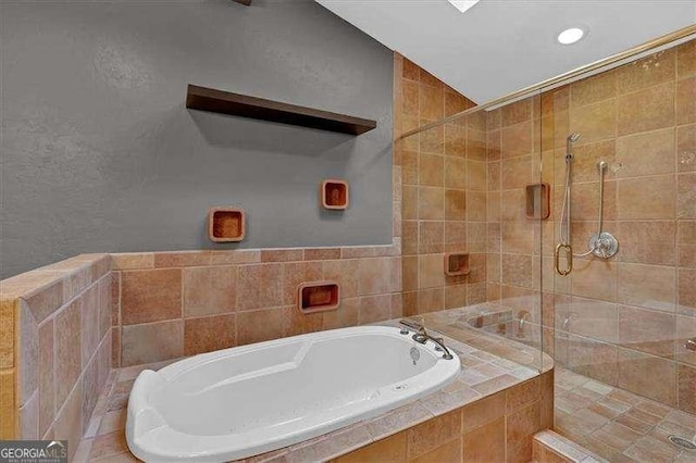 bathroom featuring shower with separate bathtub