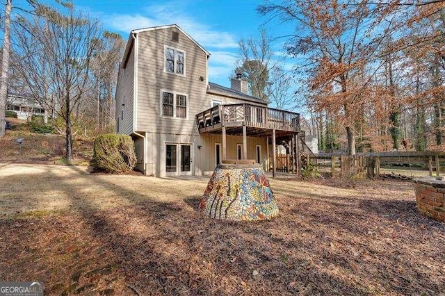 back of property featuring a deck and french doors