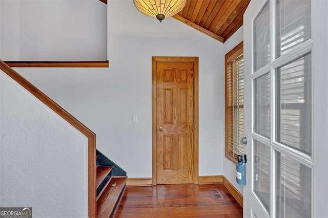 foyer with wood ceiling, dark hardwood / wood-style flooring, and vaulted ceiling