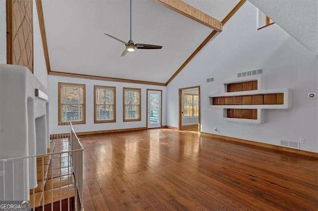 unfurnished living room with ceiling fan, ornamental molding, high vaulted ceiling, and hardwood / wood-style floors