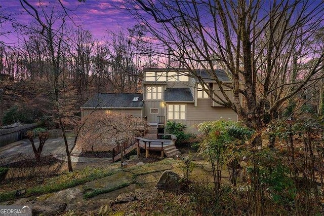 view of back house at dusk