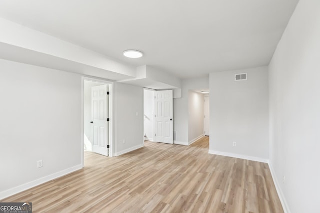 empty room with light hardwood / wood-style flooring