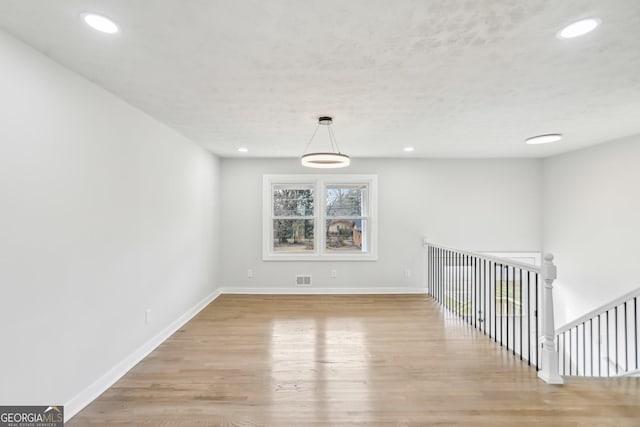 empty room with light hardwood / wood-style flooring