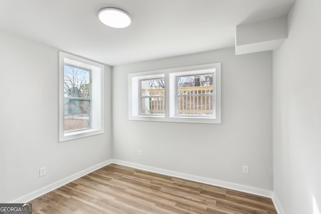 empty room with light hardwood / wood-style floors