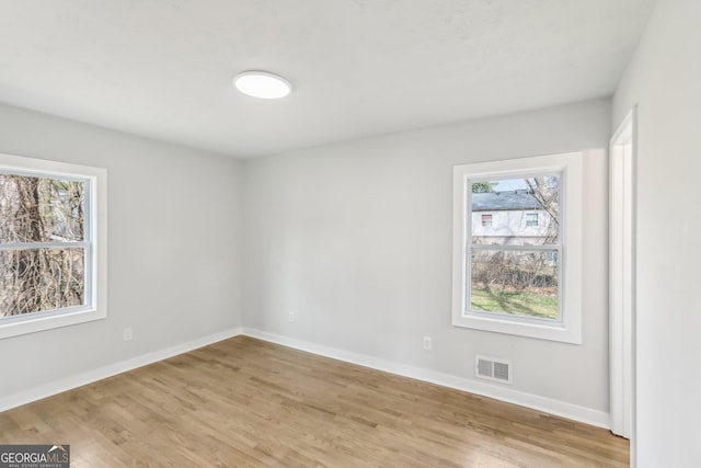 unfurnished room with light hardwood / wood-style floors