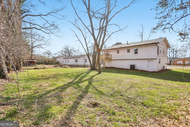 back of property featuring cooling unit and a lawn