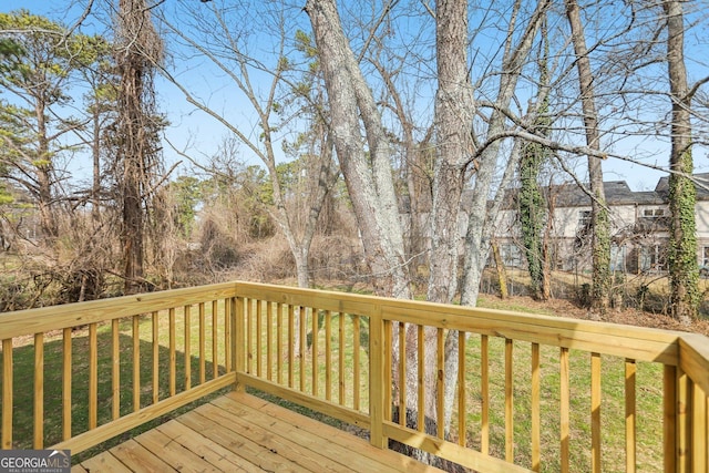 wooden deck featuring a yard