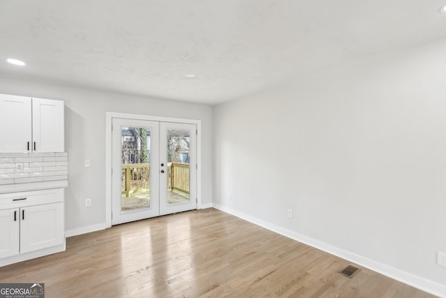 interior space with french doors and light wood-type flooring