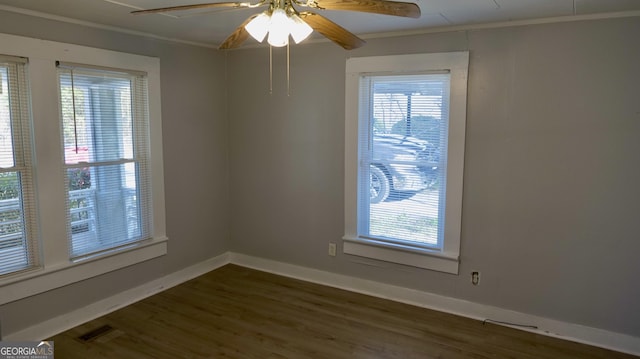 unfurnished room with dark wood-type flooring, ceiling fan, and ornamental molding