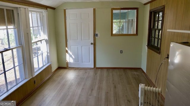 interior space featuring lofted ceiling and light wood-type flooring