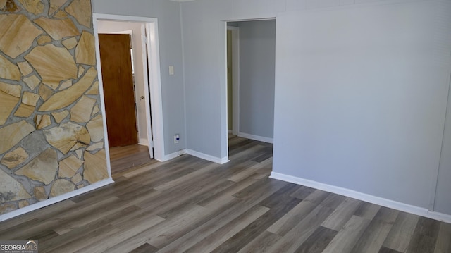 empty room featuring dark hardwood / wood-style flooring