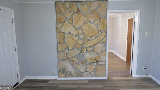 hallway featuring crown molding and hardwood / wood-style flooring