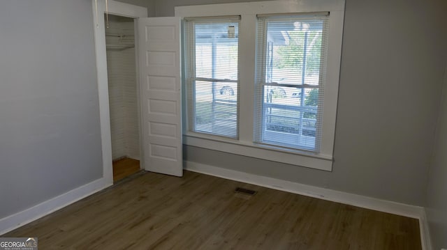 unfurnished bedroom with hardwood / wood-style floors and a closet