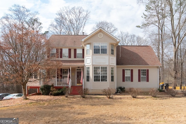 view of front of property featuring a front yard and covered porch