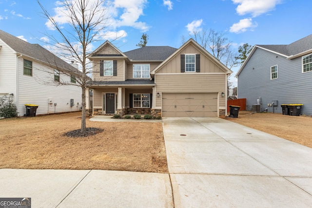 craftsman-style home with cooling unit, a garage, and a porch