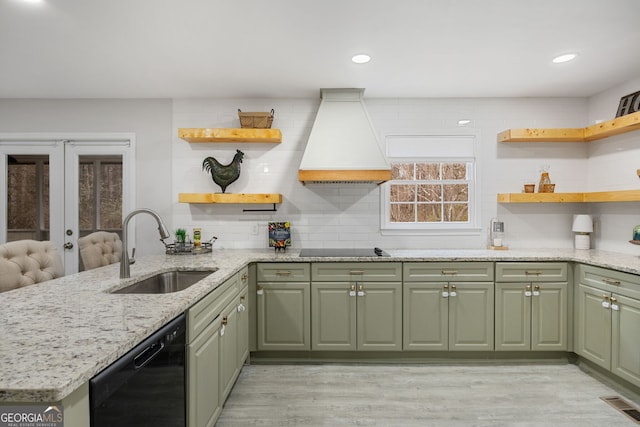 kitchen with premium range hood, sink, kitchen peninsula, light stone countertops, and black appliances