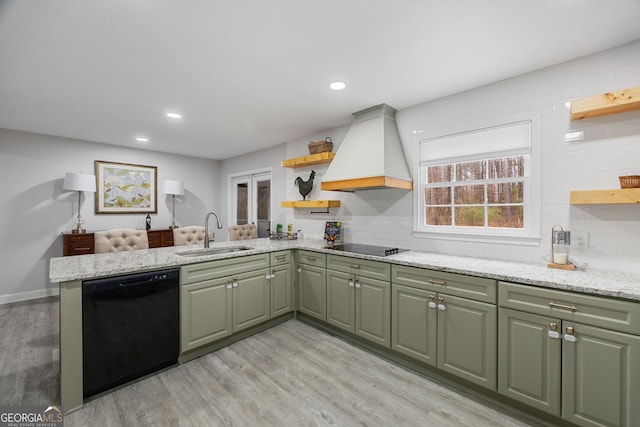 kitchen featuring sink, black appliances, custom range hood, light stone countertops, and kitchen peninsula