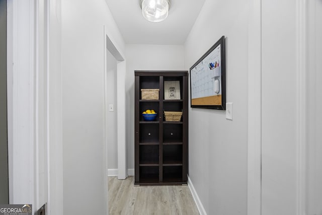 hallway with light hardwood / wood-style floors