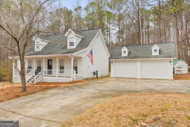 new england style home with a garage and covered porch