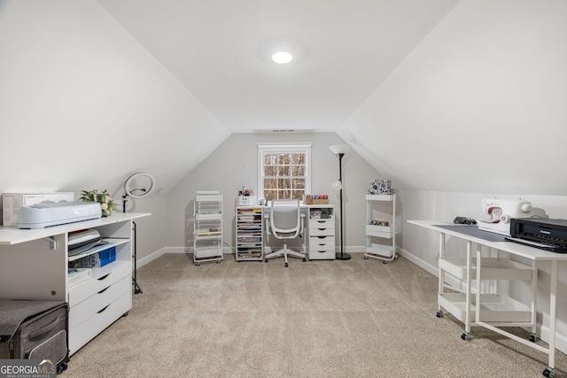 home office with vaulted ceiling and light carpet