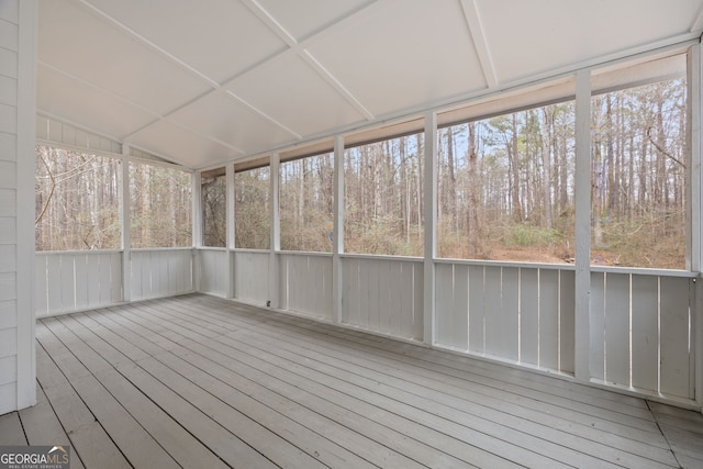 unfurnished sunroom featuring lofted ceiling