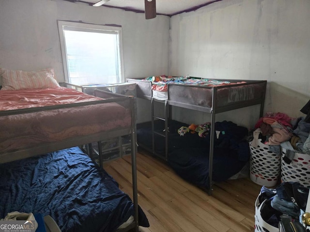 bedroom featuring wood-type flooring and ceiling fan