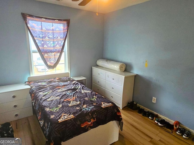 bedroom featuring hardwood / wood-style flooring and ceiling fan