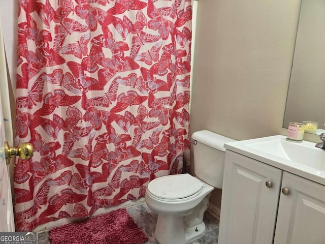 bathroom featuring vanity and toilet