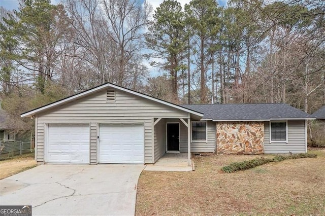 single story home featuring a garage and a front yard