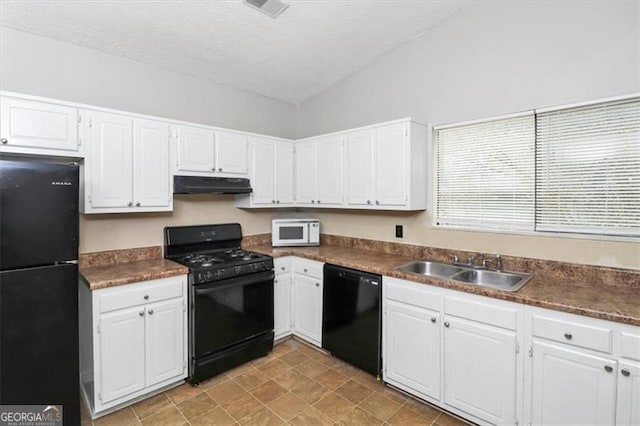 kitchen featuring sink, white cabinetry, black appliances, a textured ceiling, and vaulted ceiling