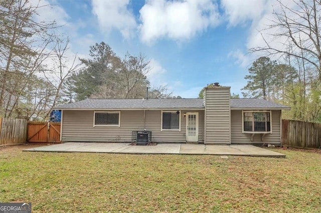 rear view of property featuring a patio and a yard