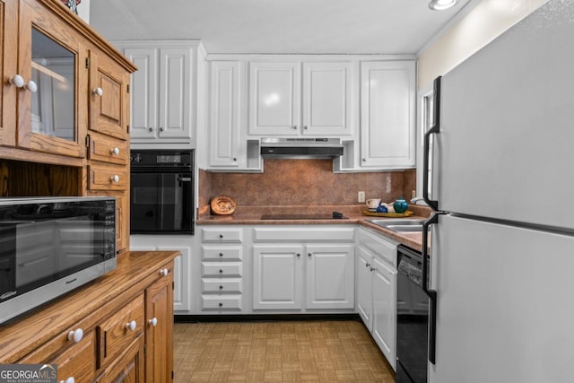 kitchen featuring sink, decorative backsplash, black appliances, and white cabinets