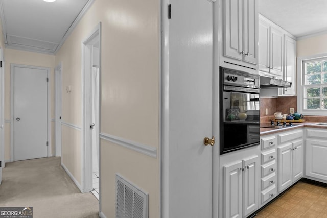 kitchen with tasteful backsplash, ornamental molding, white cabinets, and black appliances