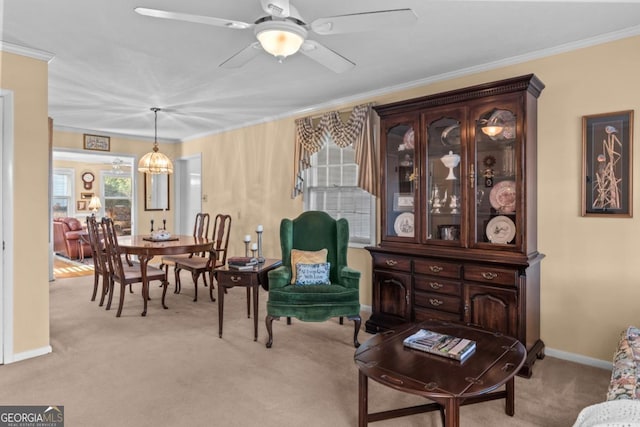 sitting room featuring ornamental molding, light colored carpet, and ceiling fan