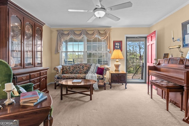 sitting room with ornamental molding, a wealth of natural light, light colored carpet, and ceiling fan