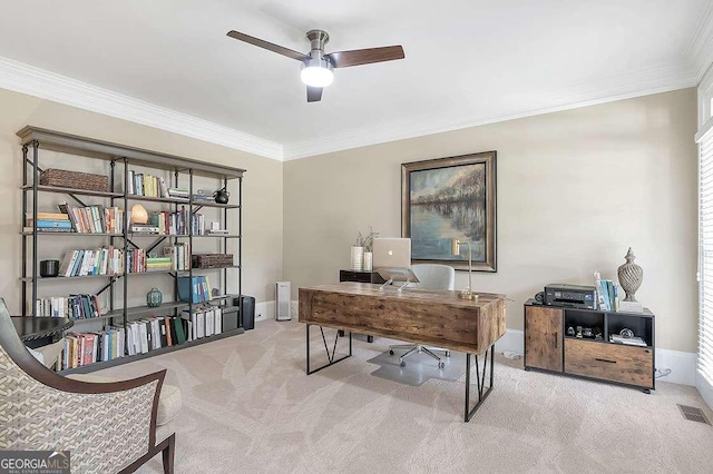 carpeted office featuring crown molding and ceiling fan