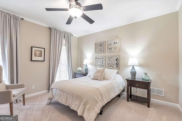 bedroom featuring crown molding, ceiling fan, and light carpet