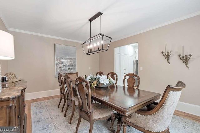 dining area with crown molding and light wood-type flooring