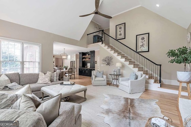 living room featuring ceiling fan, high vaulted ceiling, and light hardwood / wood-style floors