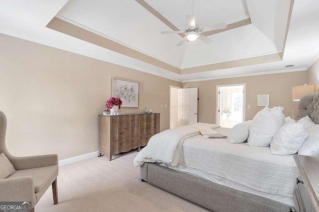 bedroom featuring crown molding, light carpet, ceiling fan, and a tray ceiling